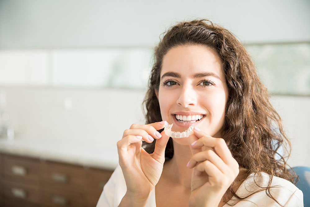 Woman with Invisalign retainer before eating