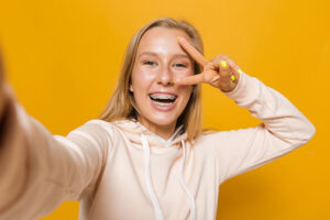 Girl taking the perfect photo with braces